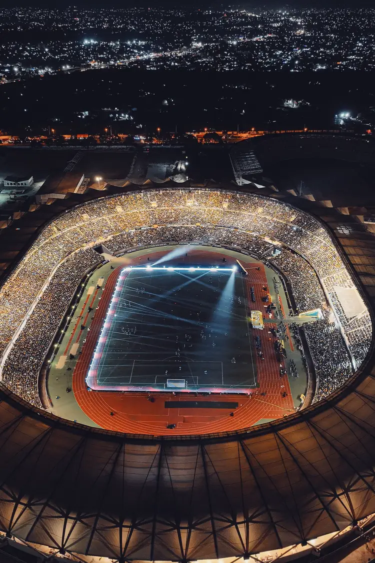 A packed stadium at night, seen from the air